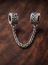 Silver Logo Safety Chain Charm - Silver Logo Safety Chain Charm — display on walnut