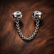 Silver Swirl Safety Chain Charm - Silver Swirl Safety Chain Charm — display on walnut