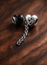 Bow Safety Chain Charm - Bow Safety Chain Charm — display on walnut