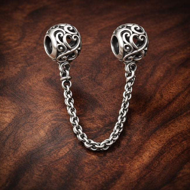 Scroll Heart Safety Chain Charm - Scroll Heart Safety Chain Charm — display on walnut