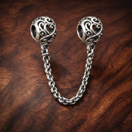 Scroll Heart Safety Chain Charm - Scroll Heart Safety Chain Charm — display on walnut