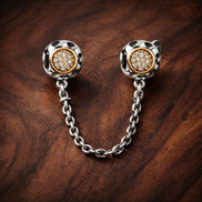 Gold Plated Sunburst Safety Chain Charm - Gold Plated Sunburst Safety Chain Charm — display on walnut