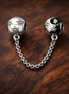Starry Safety Chain Charm - Starry Safety Chain Charm — display on walnut