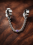 Block Letter Safety Chain Charm - Block Letter Safety Chain Charm — display on walnut