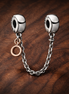 Rose Circle Safety Chain Charm - Rose Circle Safety Chain Charm — display on walnut