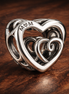 Entwined Infinite Hearts Charm — display on walnut