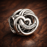 Family Always Encircled Heart Charm — display on walnut