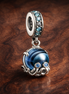 Murano Glass Cute Octopus Dangle Charm — display on walnut