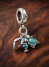 Fish, Sea Turtle & Conch Triple Dangle Charm — display on walnut