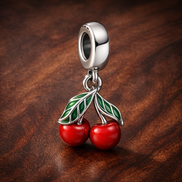 Asymmetrical Cherry Fruit Dangle Charm — display on walnut