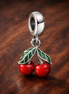 Asymmetrical Cherry Fruit Dangle Charm — display on walnut
