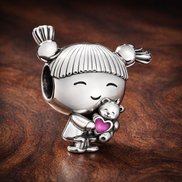 Little Girl Charm — display on walnut