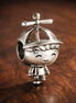 Little Boy Charm — display on walnut
