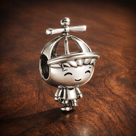 Little Boy Charm — display on walnut