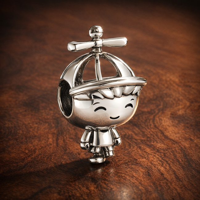 Little Boy Charm — display on walnut