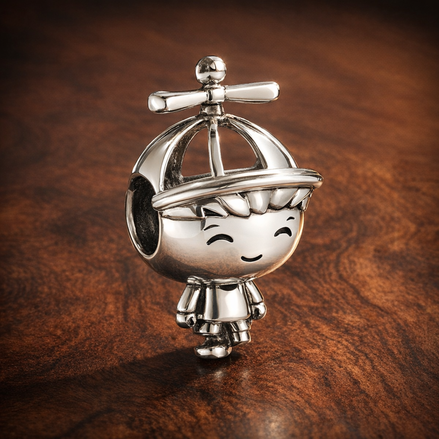 Little Boy Charm — display on walnut