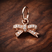 Rose Pav? Bow Dangle Charm - Rose Pav? Bow Dangle Charm — display on walnut