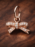Rose Pav? Bow Dangle Charm - Rose Pav? Bow Dangle Charm — display on walnut