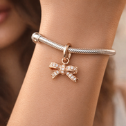 Rose Pav? Bow Dangle Charm - Rose Pav? Bow Dangle Charm — worn on wrist