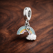 Rainbow Cloud Dangle Charm - Rainbow Cloud Dangle Charm — display on walnut