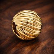 Gold Plated Ribbed Shell Charm - Gold Plated Ribbed Shell Charm — display on walnut