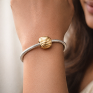 Gold Plated Ribbed Shell Charm - Gold Plated Ribbed Shell Charm — worn on wrist