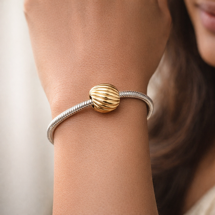Gold Plated Ribbed Shell Charm - Gold Plated Ribbed Shell Charm — worn on wrist
