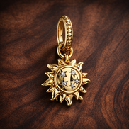 Gold Plated Sun Dangle Charm - Gold Plated Sun Dangle Charm — display on walnut