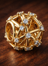 Gold Plated Orbital Crystal Charm - Gold Plated Orbital Crystal Charm — display on walnut
