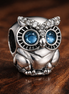 Sparkling Owl Charm — display on walnut