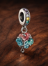 Rainbow Clover Dangle Charm - Rainbow Clover Dangle Charm — display on walnut