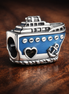 Anchored Cruise Ship Charm — display on walnut