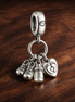 Baby Bottle and Shoes Dangle Charm — display on walnut