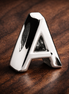 Letter A Alphabet Charm — display on walnut