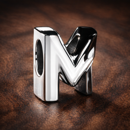 Letter M Alphabet Charm — display on walnut
