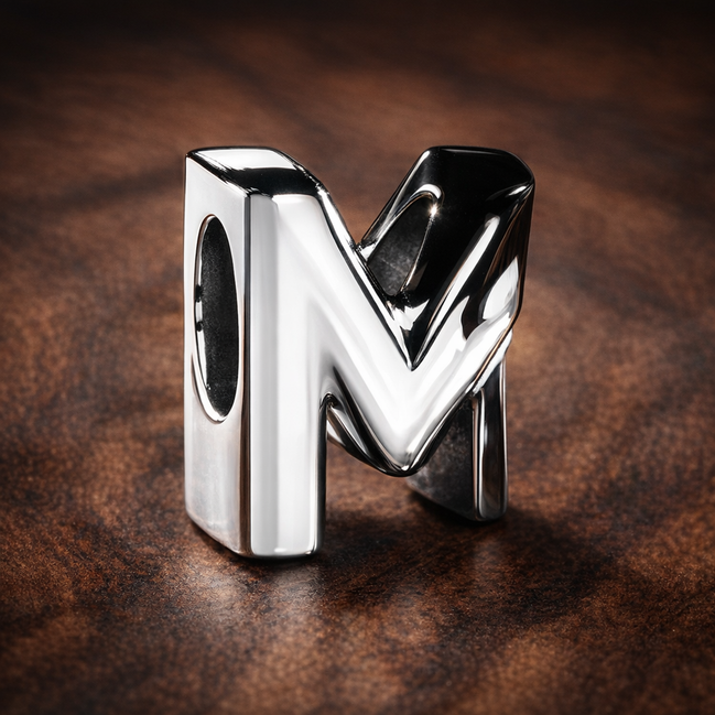 Letter M Alphabet Charm — display on walnut