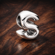 Letter S Alphabet Charm — display on walnut