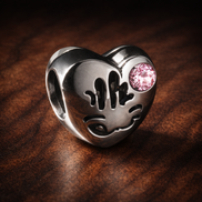 Pink Smile Bead - Pink Smile Bead Charm — display on walnut