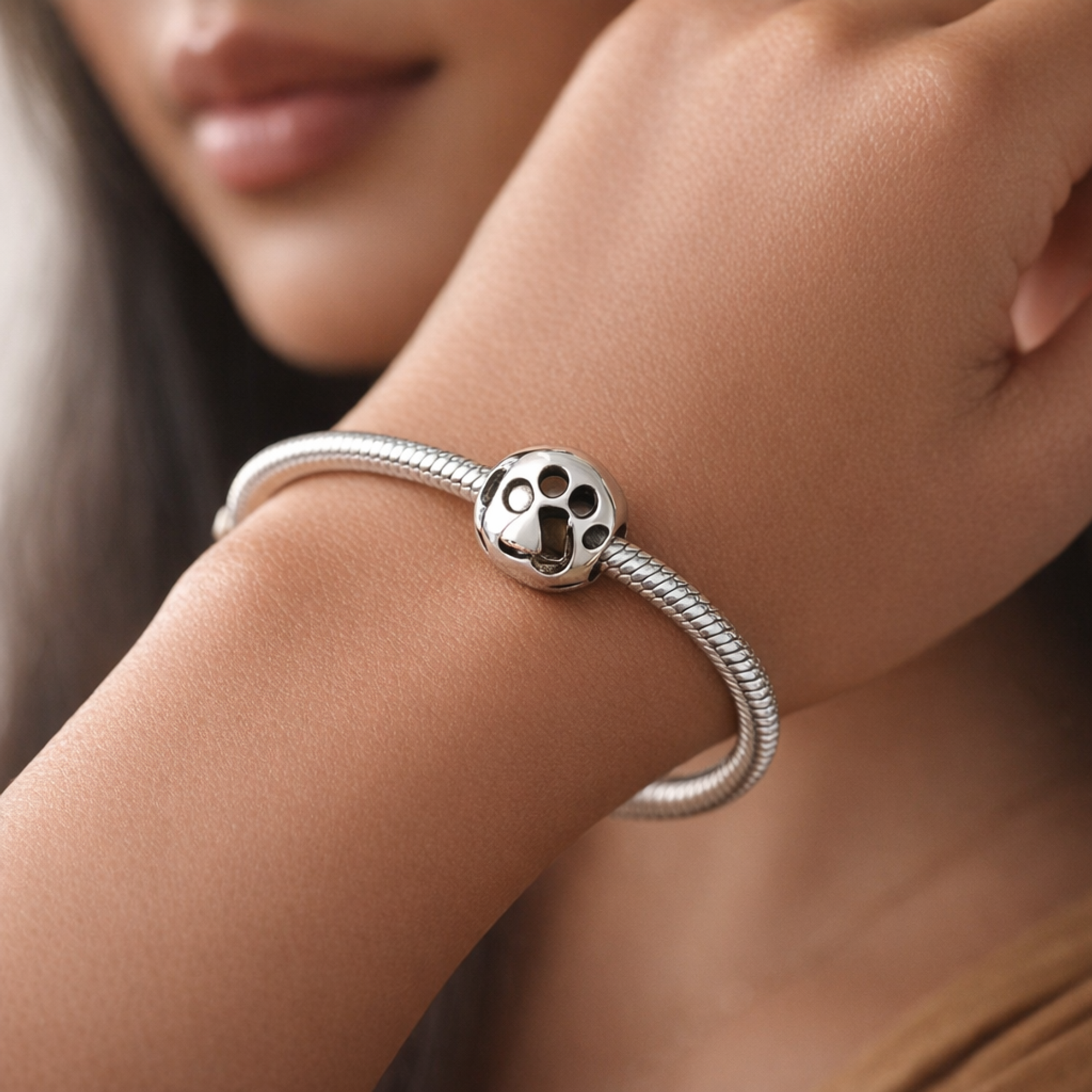Openwork Paw Print Charm — worn on wrist