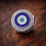Blue Evil Eye Medallion - Blue Evil Eye Medallion Charm — display on walnut