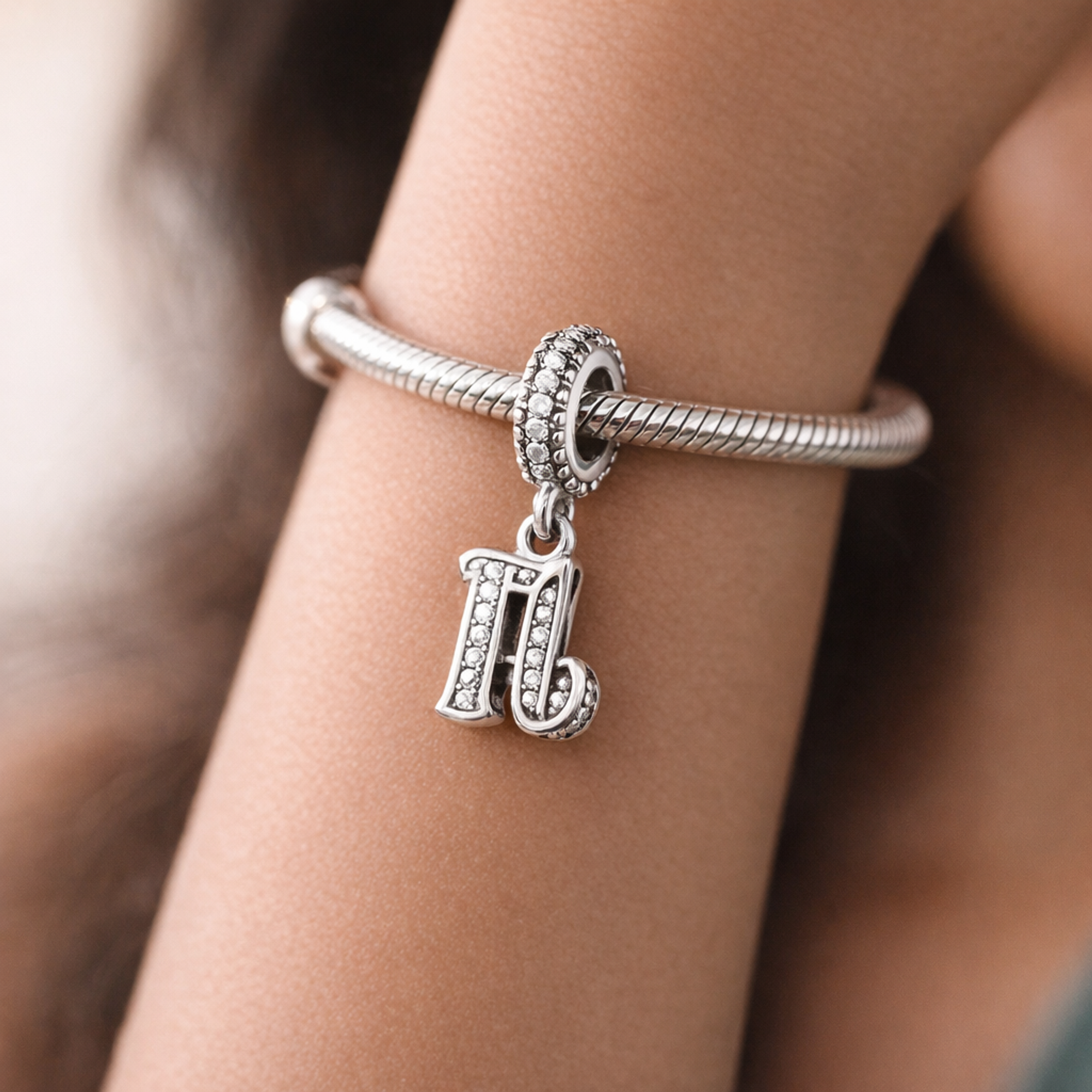 16th Celebration Charm — worn on wrist
