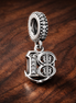 18th Celebration Dangle Charm — display on walnut