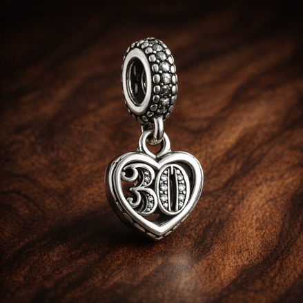 30th Celebration Dangle Charm — display on walnut