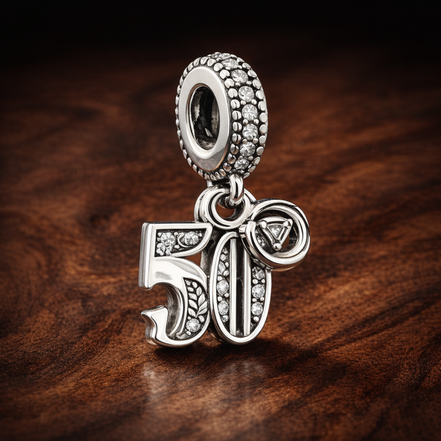 50th Celebration Dangle Charm — display on walnut