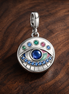 Rainbow Evil Eye Medallion - Rainbow Evil Eye Medallion Charm — display on walnut