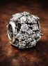 Sparkling Herbarium Cluster Round Charm — display on walnut