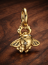 Disney Aladdin Scarab Beetle Dangle Charm — display on walnut