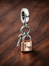 Two-tone Key, Padlock & Heart Triple Dangle Charm — display on walnut