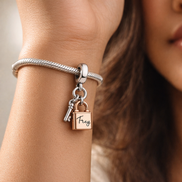 Two-tone Key, Padlock & Heart Triple Dangle Charm — worn on wrist