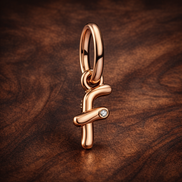 Letter F Script Alphabet Dangle Charm — display on walnut